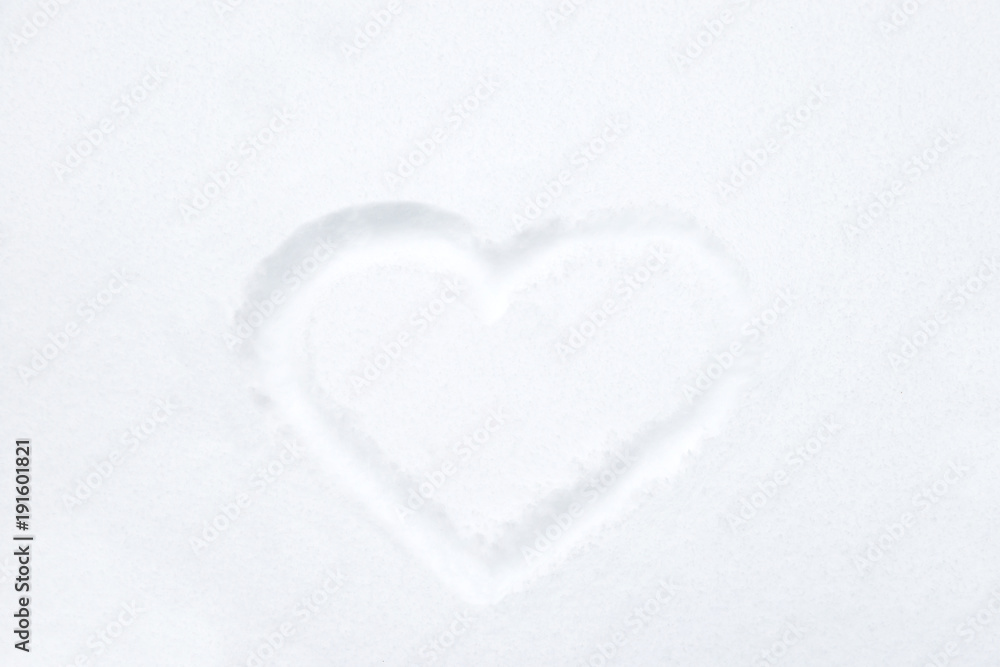 Heart shape drawing on white snow as love valentine background