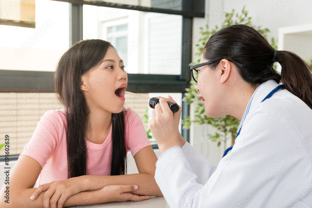 doctor holding flashlight to examination throat doctor holding flashlight to examination throat