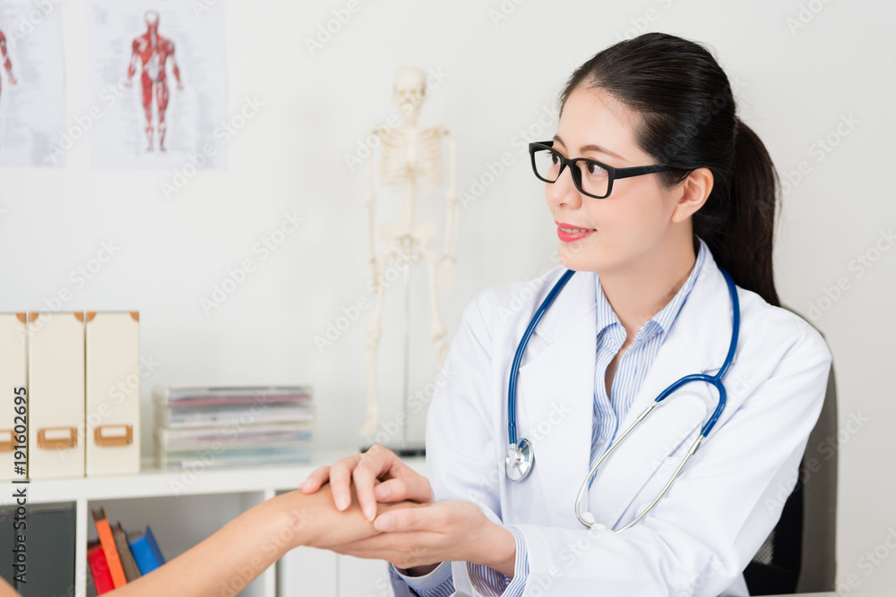 attractive woman doctor touching patient hand attractive woman doctor touching patient hand