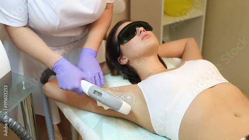 Therapist Removing Hair Of Young Woman's Armpit In Cosmetic Beauty Clinic