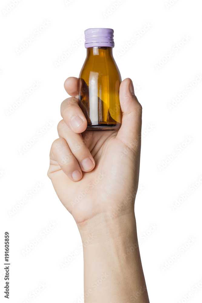 Woman's hand holding empty small brown medicine bottle liquids transparent on white background. File contains a clipping path. Woman's hand holding empty small brown medicine bottle liquids transparent on white background. File contains a clipping path.