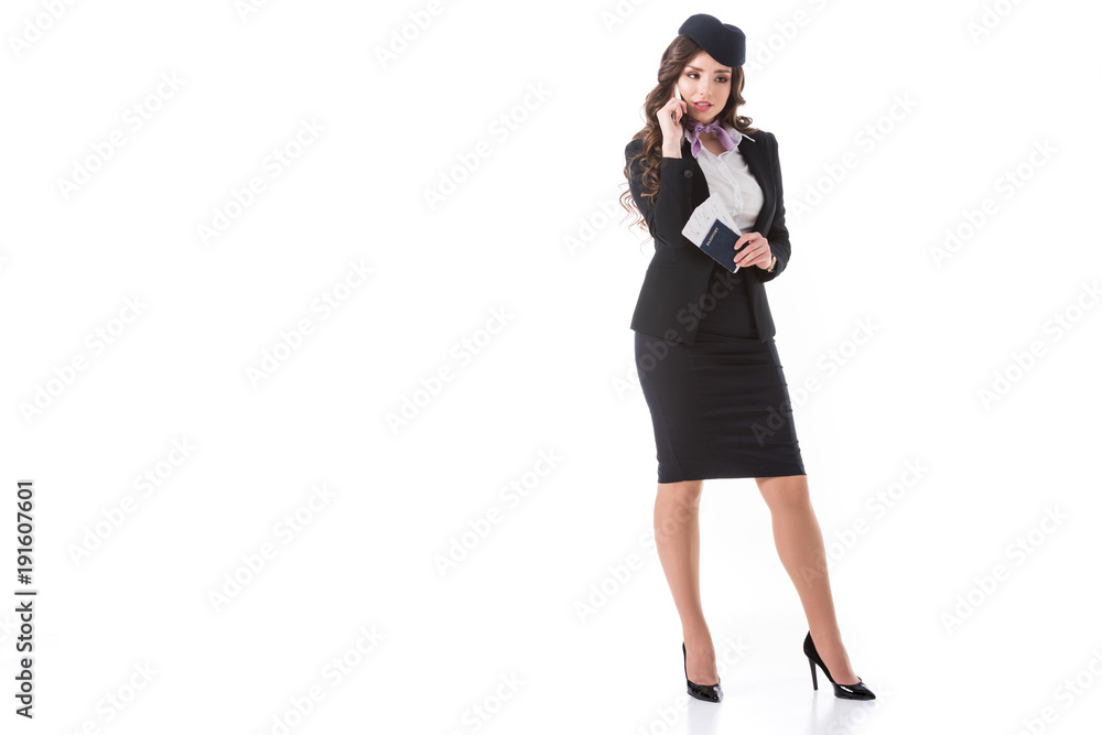 beautiful stewardess talking by smartphone and holding tickets with passport isolated on white beautiful stewardess talking by smartphone and holding tickets with passport isolated on white