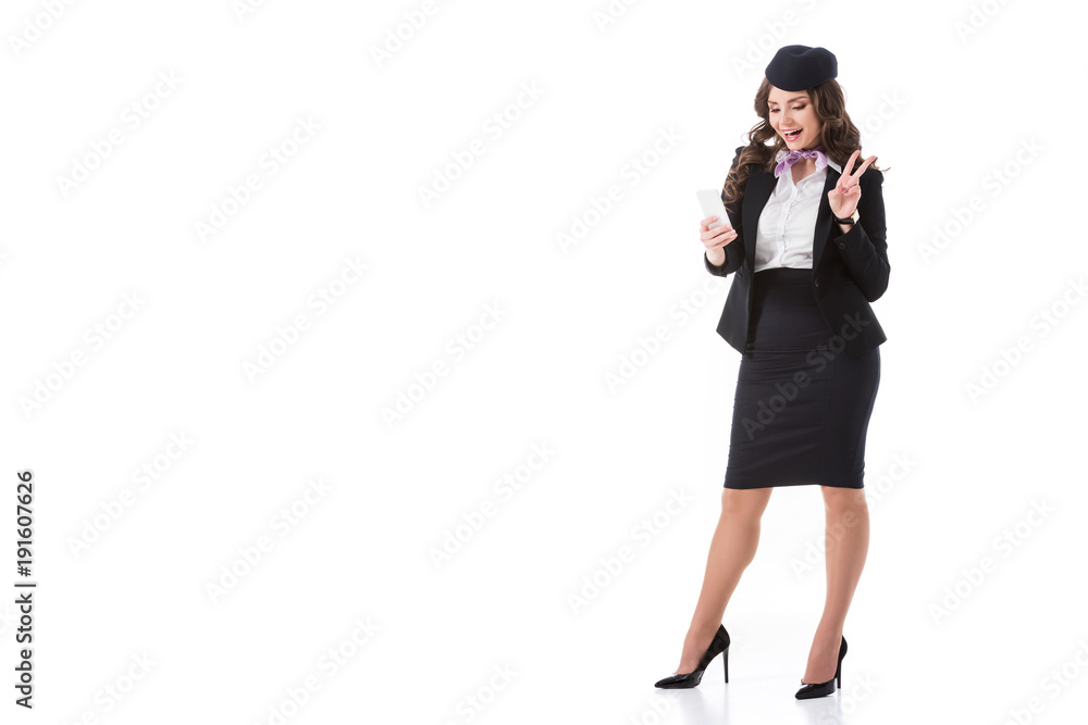 attractive stewardess taking selfie and showing peace sign isolated on white attractive stewardess taking selfie and showing peace sign isolated on white