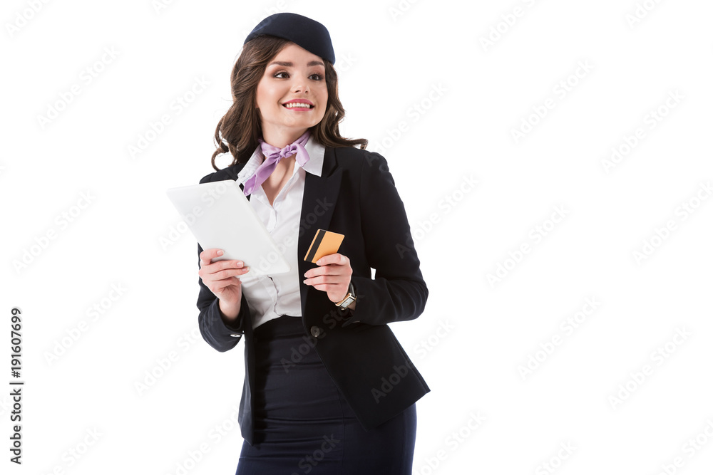 smiling attractive stewardess holding tablet and credit card isolated on white smiling attractive stewardess holding tablet and credit card isolated on white