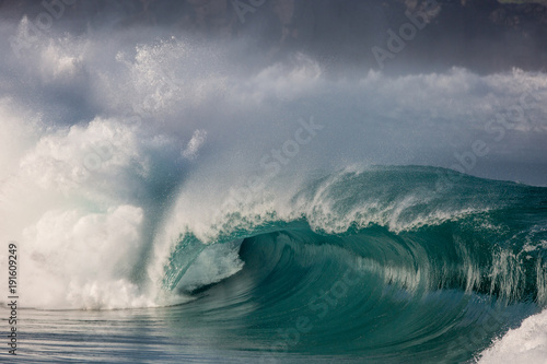 dramatic stormy wave breaking  in waimea bay, hawaii on the north shore of Oahu. 