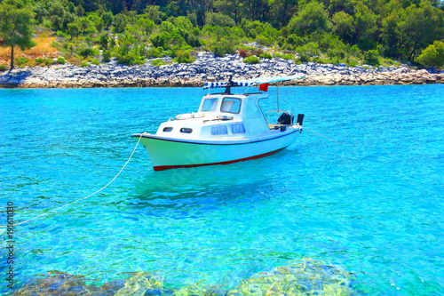 Boat fixed on rocky beach, beautiful blue sea, Island Hvar, Croatia
