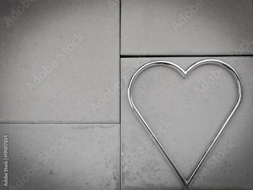 Valentine day metal shape heart and stone cement background love date anniversary photo