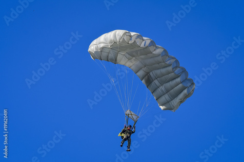 Skydriver jumping with parachut with blue cloud sky background