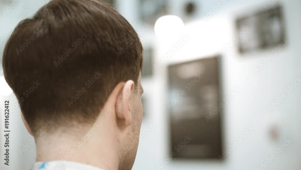 Man getting a haircut by a hairdresser. Man getting a haircut by a hairdresser.