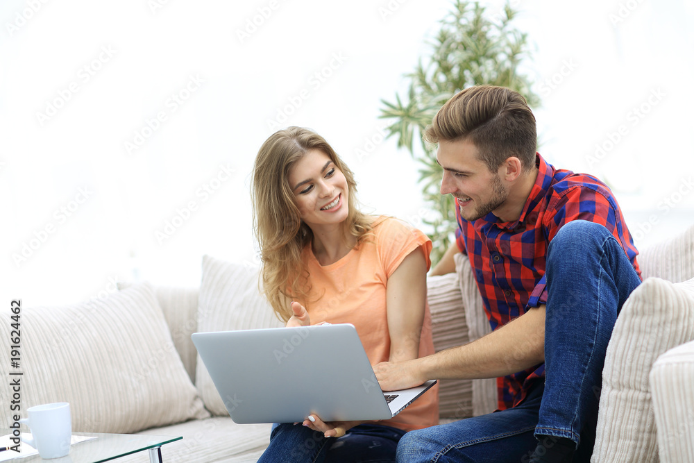 young man and his girlfriend looking at pictures on the laptop. young man and his girlfriend looking at pictures on the laptop.
