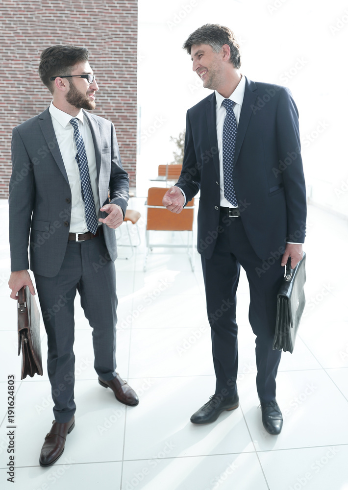 Two company employees discuss business issues Two company employees discuss business issues
