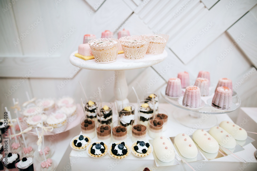 Delicious white wedding reception candy bar dessert table Delicious white wedding reception candy bar dessert table