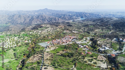 Aerial bird eye view of famous landmark tourist destination valley Kato Lefkara village, Larnaca, Cyprus. Ceramic tiled house roofs, at south of Troodos hills, Kionia and river Sirkatis from above. photo