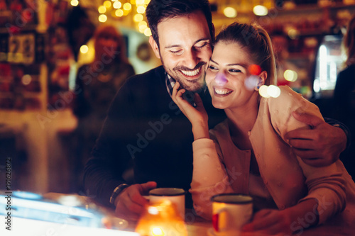 Romantic couple dating in pub at night photo