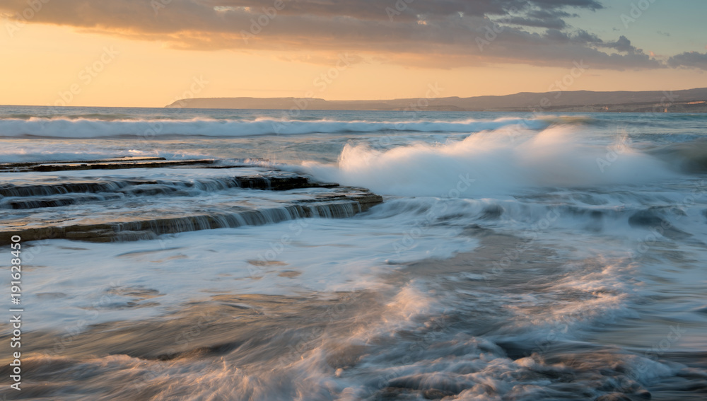 Dramatic Powerful waves crashing with power on sea rock plates