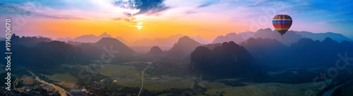 Aerial view of Vang vieng with mountains and balloon at sunset. photo