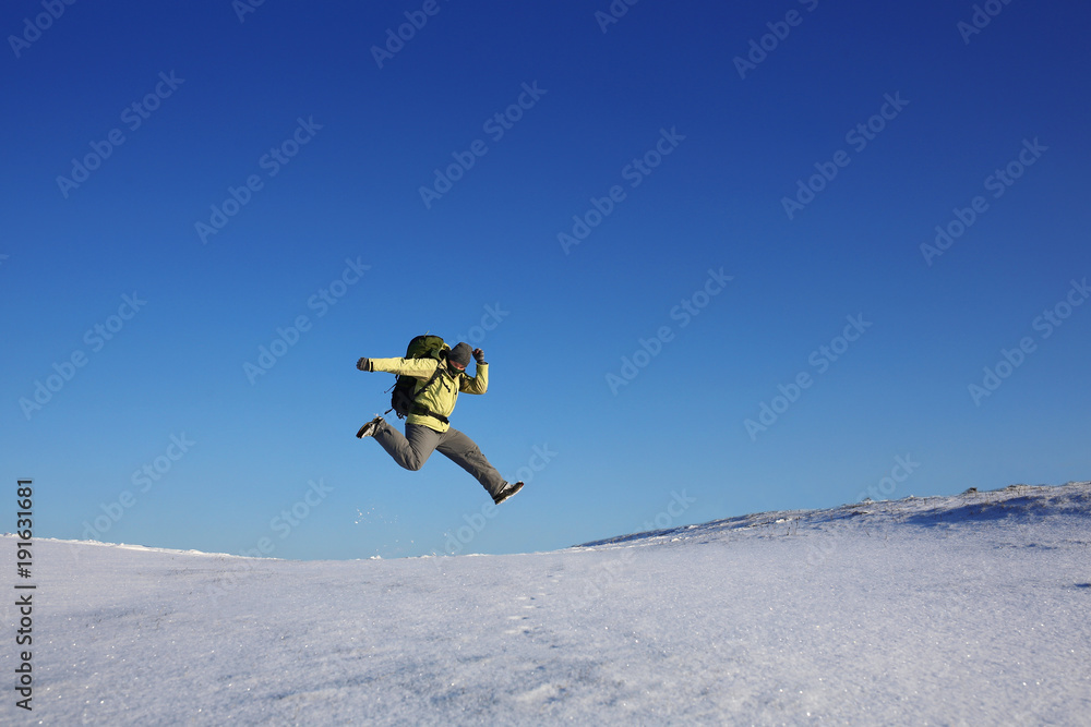 fly jump hiker in winter.