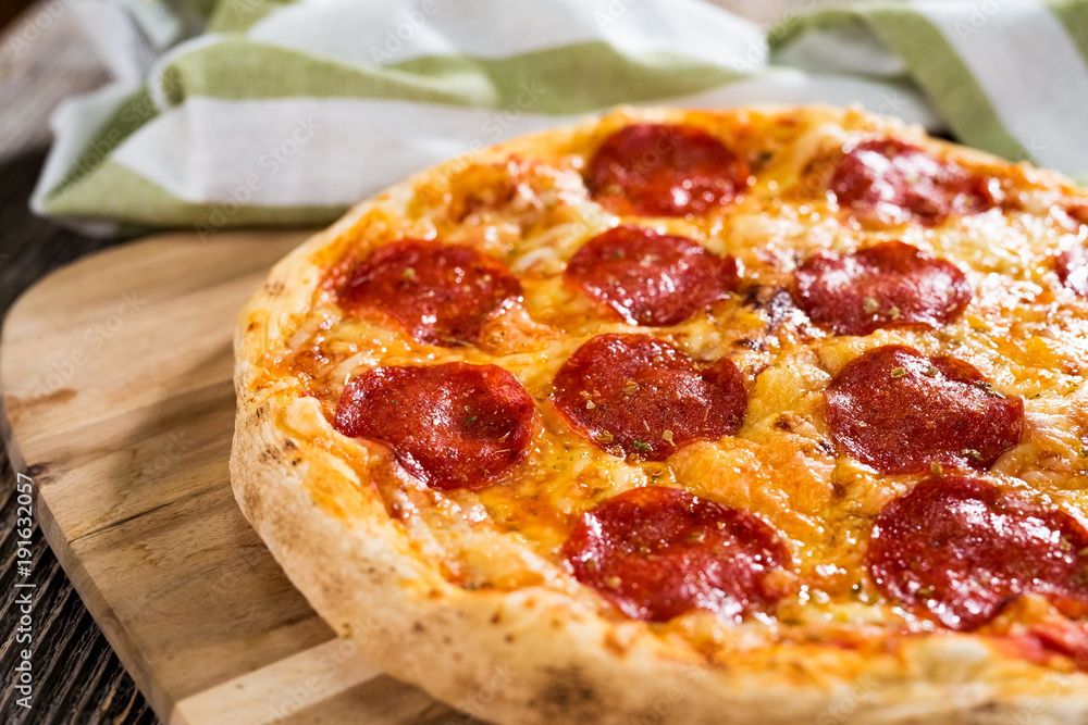 Pepperoni pizza on rustic background Pepperoni pizza on rustic background