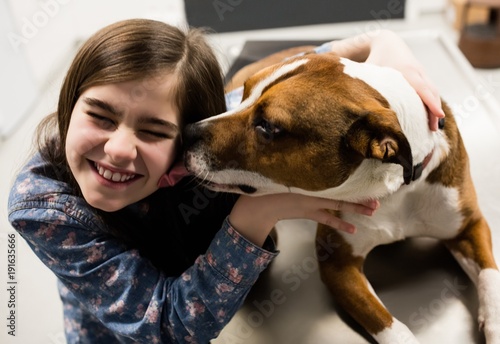 Girl playing with her pet dog photo