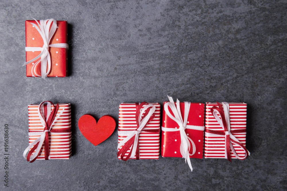 Valentines day concept with red heart and gift boxes over stone background. Valentines day concept with red heart and gift boxes over stone background.