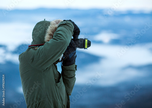 tourist takes a photo on the mountainside