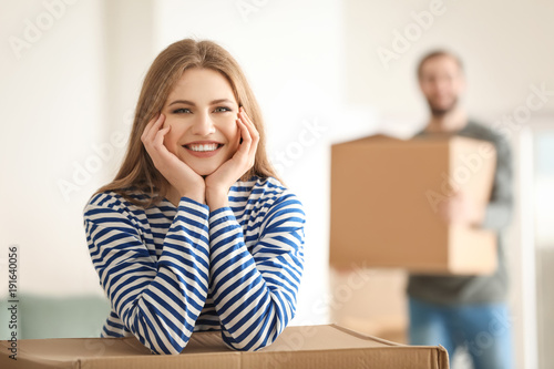 Young couple with boxes ind...