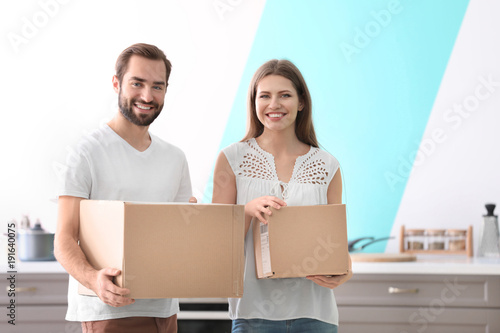 Young couple with boxes ind...