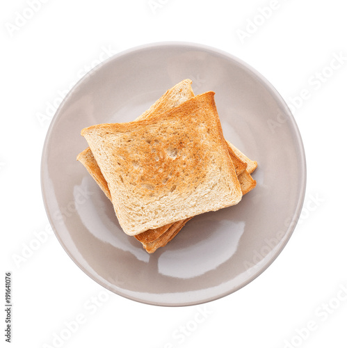 Plate with toasted bread on white background