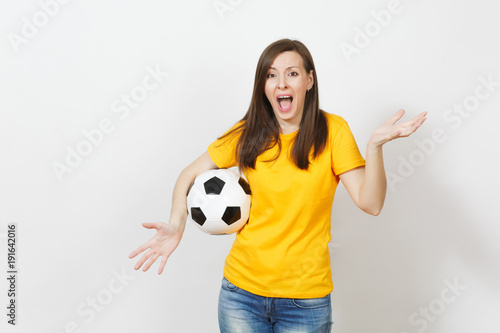 Beautiful European young angry screaming woman, football fan or player in yellow uniform holding soccer ball isolated on white background. Sport, play football, health, healthy lifestyle concept.