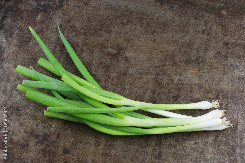 Fresh spring onions on a grungy metal background Fresh spring onions on a grungy metal background