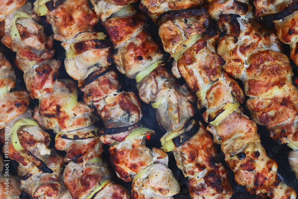 a shish kebab is fried on coals. barbecue background. a shish kebab is fried on coals. barbecue background.