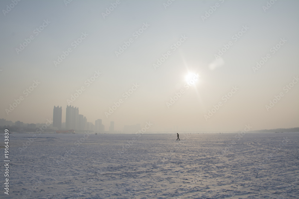 lonely wanderer on frozen lake