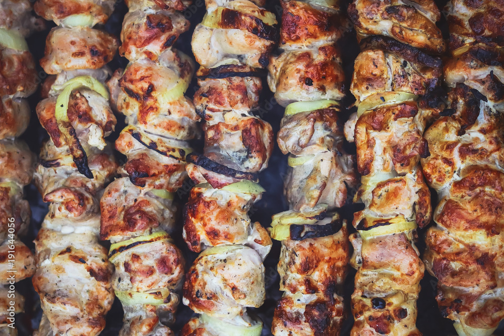 a shish kebab is fried on coals. barbecue background. a shish kebab is fried on coals. barbecue background.