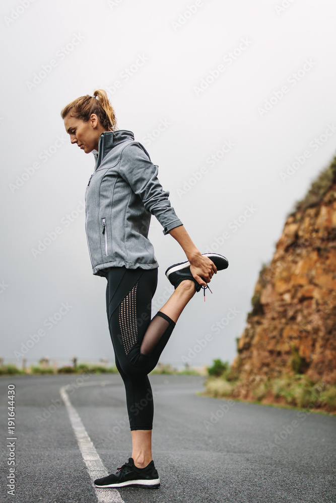Young woman exercising in jogging gear