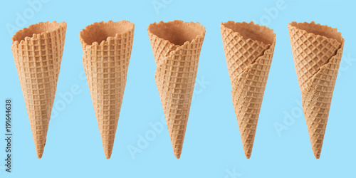 Various ice cream cones isolated on blue background.