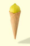 Ice cream cone with lime on bright background. Minimal style.  Holiday concept.