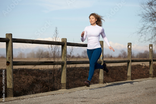 woman running in fall winter season © Stocked House Studio