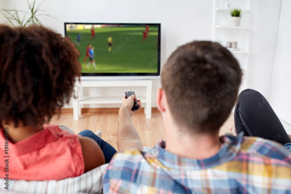 friends watching soccer game on tv at home friends watching soccer game on tv at home