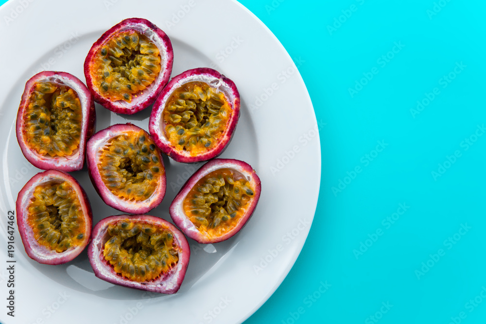 Passion fruit on a white plate on blue napkin Outdoor background Passion fruit on a white plate on blue napkin Outdoor background