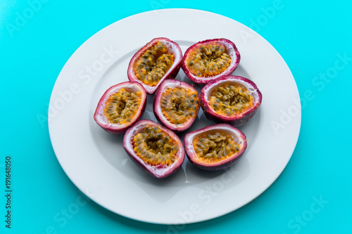 Passion fruit on a white plate on blue napkin Outdoor background