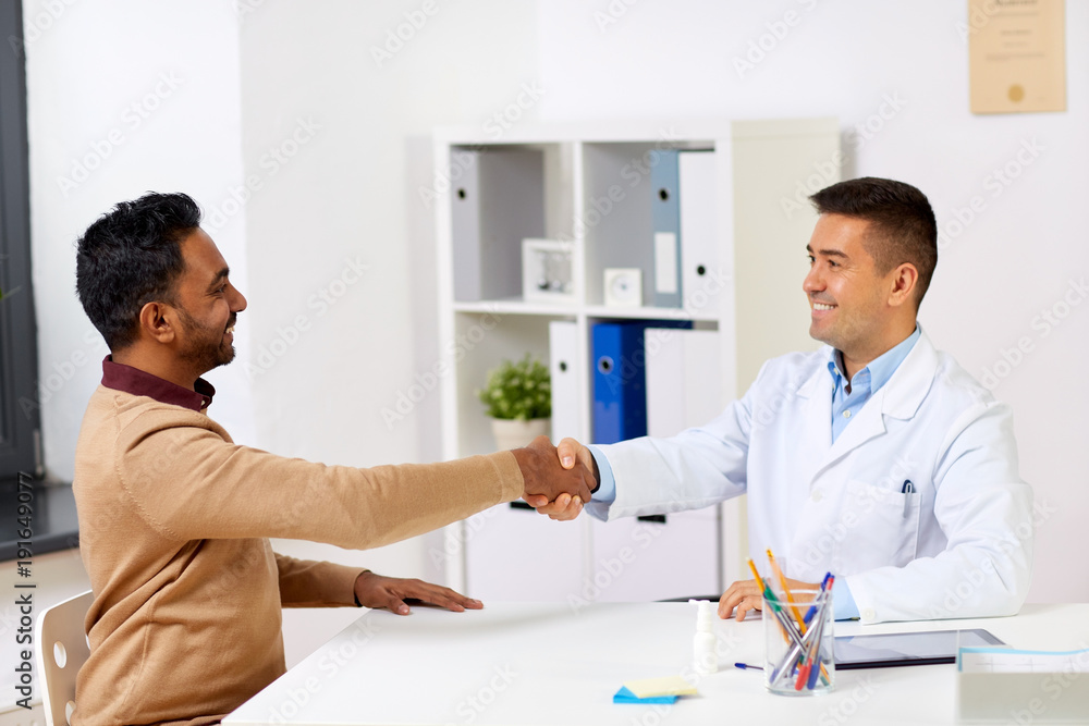 doctor and male patient shaking hands at hospital doctor and male patient shaking hands at hospital