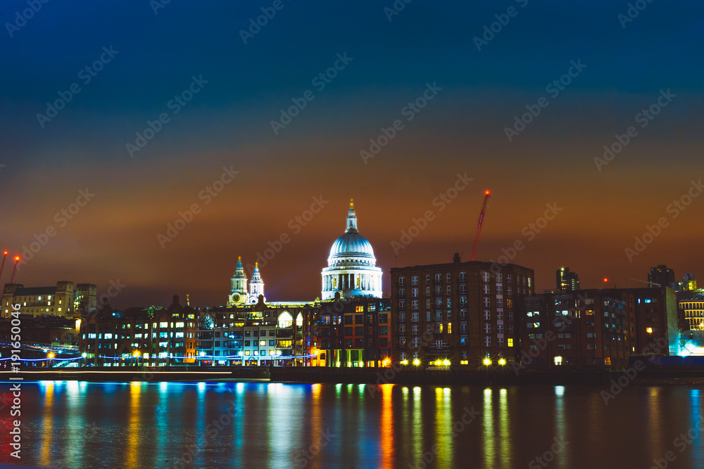 thames river at night with sant pauls church in the middle