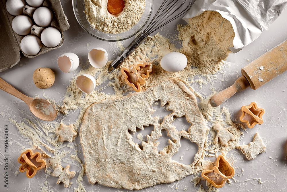 Baking concept: raw dough for biscuit, eggs, flour, cutters in the shape of star and butterfly on a white table. Top view. Baking concept: raw dough for biscuit, eggs, flour, cutters in the shape of star and butterfly on a white table. Top view.