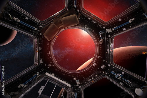 Fototapeta Naklejka Na Ścianę i Meble -  View from a porthole of space station on the Mars background. Elements of this image furnished by NASA.