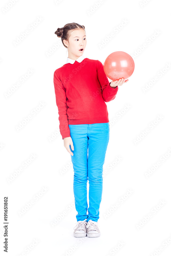 Portrait of playful girl posing with gymnastic ball on white background Portrait of playful girl posing with gymnastic ball on white background