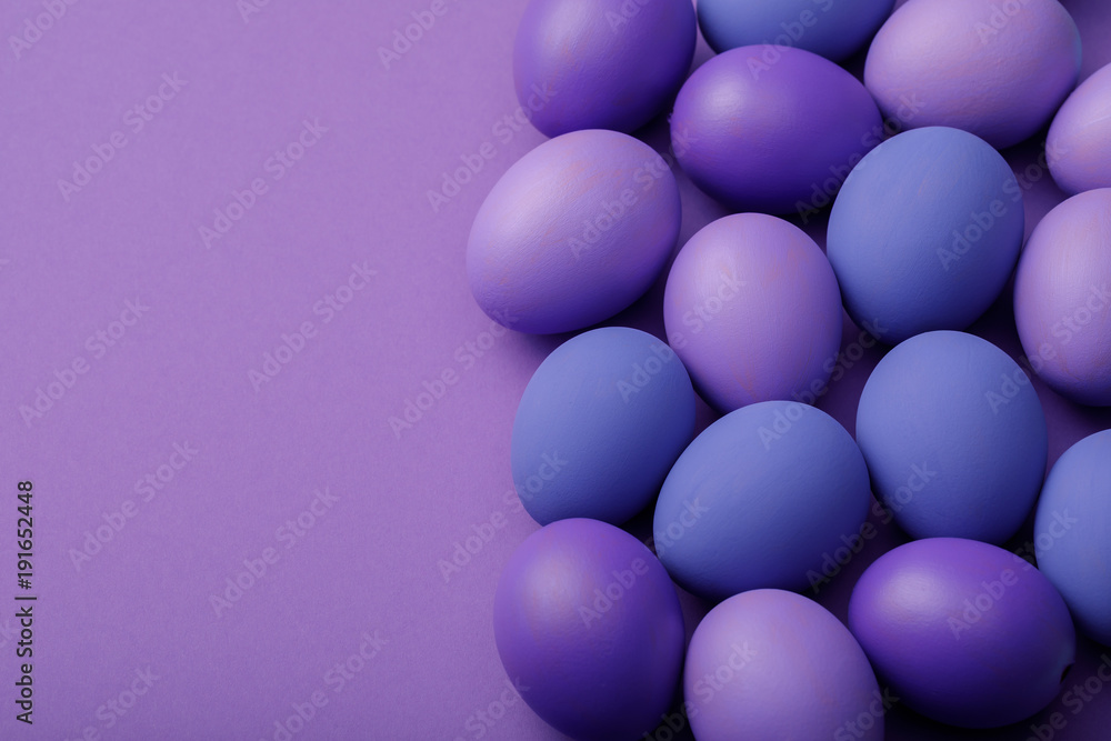 Purple easter eggs on a paper background with space for text