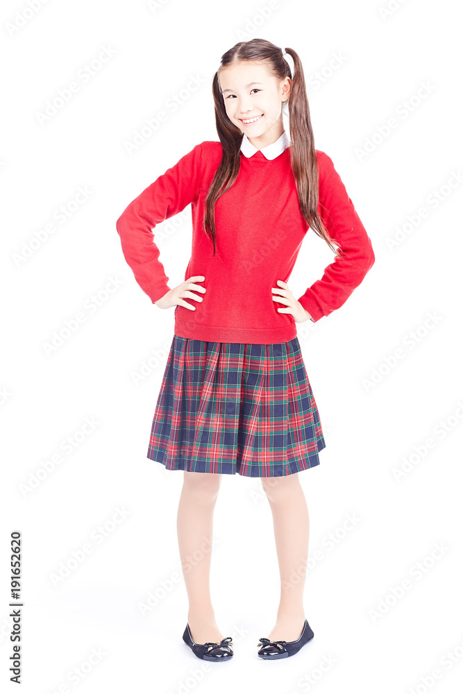 Asian female elementary student in school uniform posing on white background Asian female elementary student in school uniform posing on white background