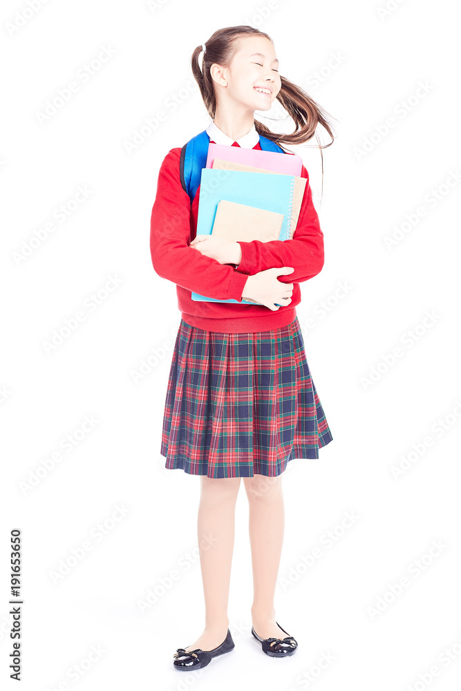 Portrait of female elementary student in school uniform holding notebooks and textbooks Portrait of female elementary student in school uniform holding notebooks and textbooks