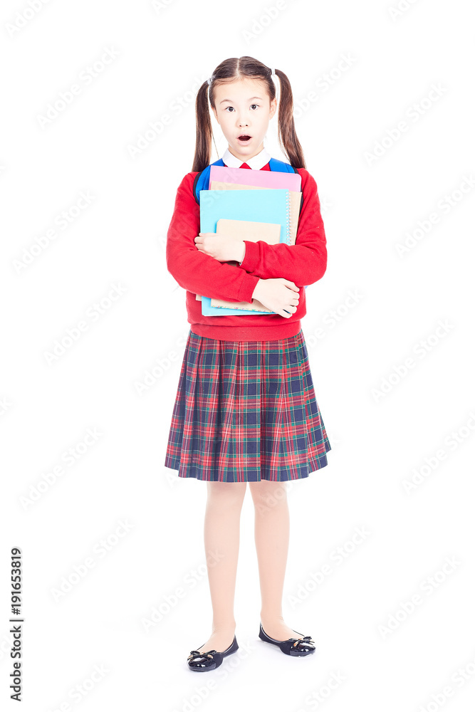 Portrait of female elementary student in school uniform holding notebooks and textbooks Portrait of female elementary student in school uniform holding notebooks and textbooks