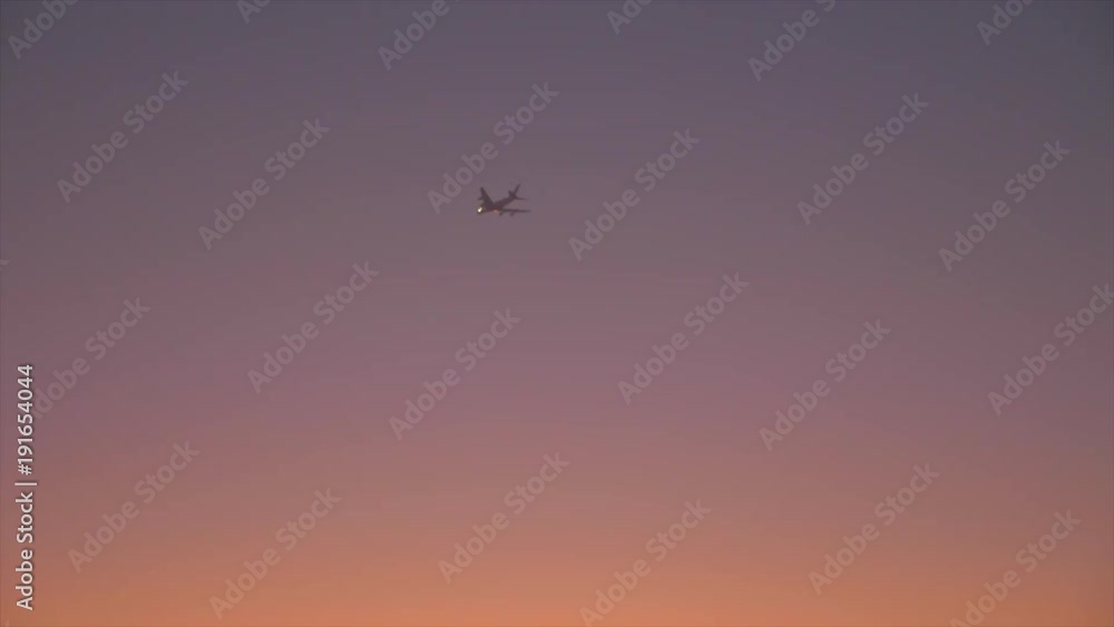 Aeroplane flying in evening sky over desert. Colorful sky in evening desert Aeroplane flying in evening sky over desert. Colorful sky in evening desert